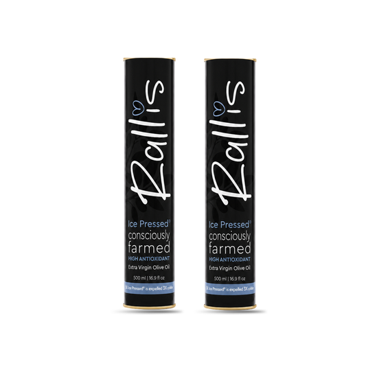 Two black cylindrical tubes of Rallis Ice Pressed Consciously Farmed Extra Virgin Olive Oil on a white background.