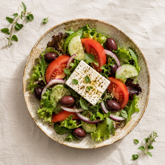 Greek Salad on a Pottery Plate on a Linen Tablecloth